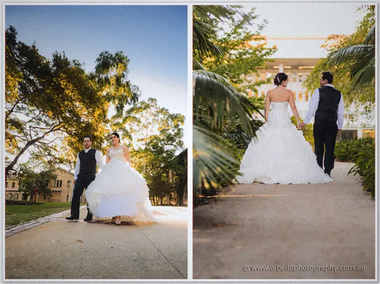The newlyweds strolling a sunlit garden path, her full ruffled gown catching the low afternoon light.