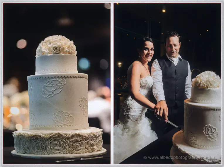 A three-tier ivory rose-covered cake, then Allison and Greg slicing it together in the lamplight.