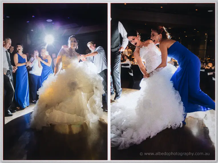 Allison rocks out mid-dance before a bridesmaid in blue helps hoist her enormous tulle skirt off the floor.
