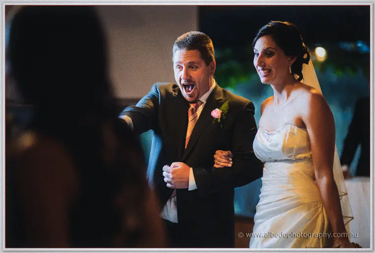 Mark points excitedly as Felicity grins beside him at the evening reception.