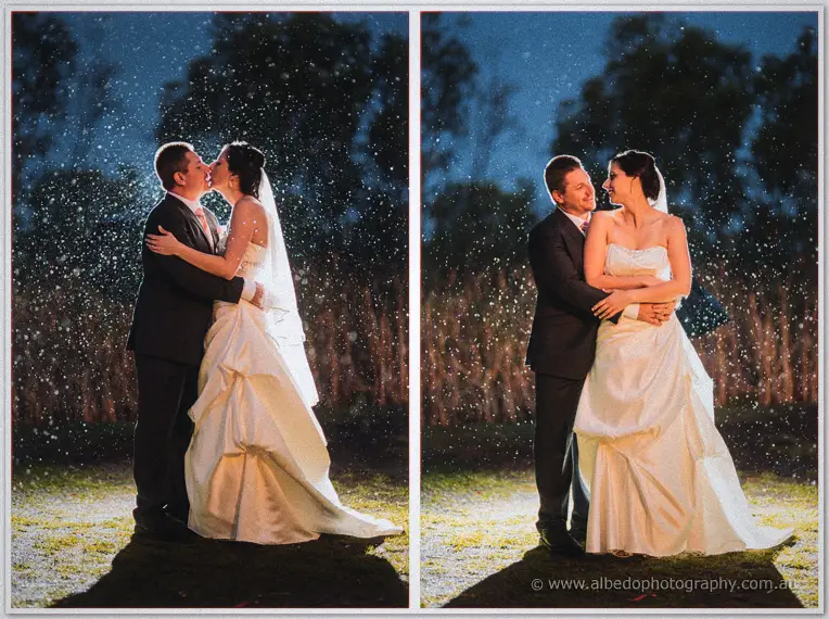 A two-frame series of the newlyweds kissing and embracing in falling night rain.