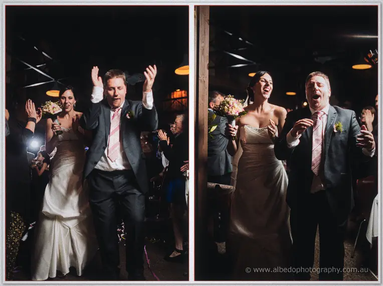 A two-frame series of the couple cheering their way into the barn reception.