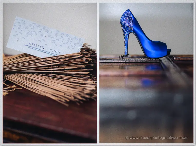 The couple's stationery card resting on twine bundles beside Kristyn's sparkling royal blue stiletto.