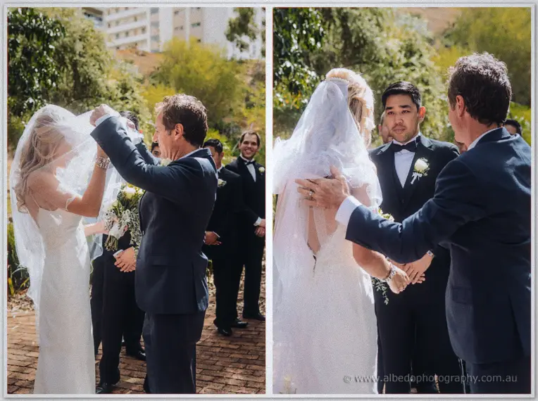 Kristyn's father lifts her veil as she joins Chris beneath the trees at the garden ceremony.