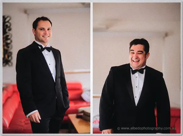 Two laughing groomsmen in tuxedos pose in a paired frame beside a bright red lounge suite