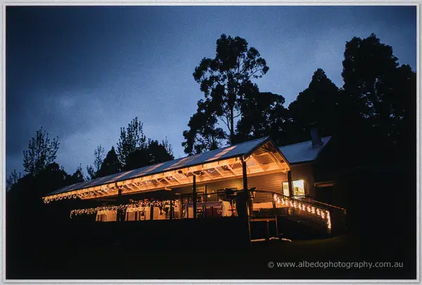 Silkwood Winery glowing with festoon lights under a deep blue evening sky in Pemberton.