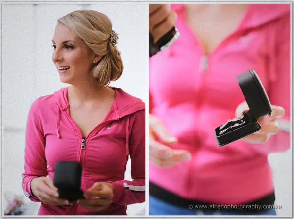 A bridesmaid in a pink hoodie grins holding an open ring box, with the rings gleaming in a close-up