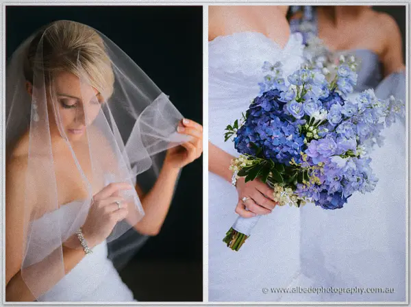 Sarah touches her sheer veil in profile, beside her hand cradling the blue and white bouquet