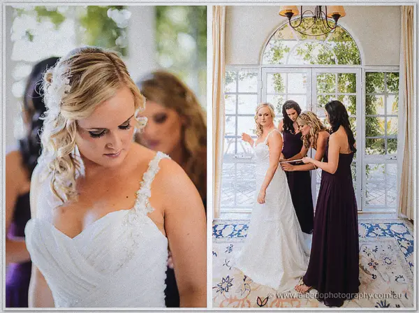Bridesmaids in plum gowns fasten Ashley's beaded gown straps in a vine-framed glass conservatory
