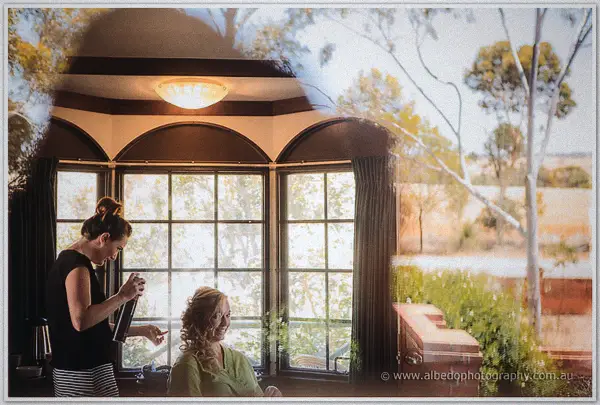 Double exposure blends Tash's hair trial by the bay window with eucalypts and paddocks outside