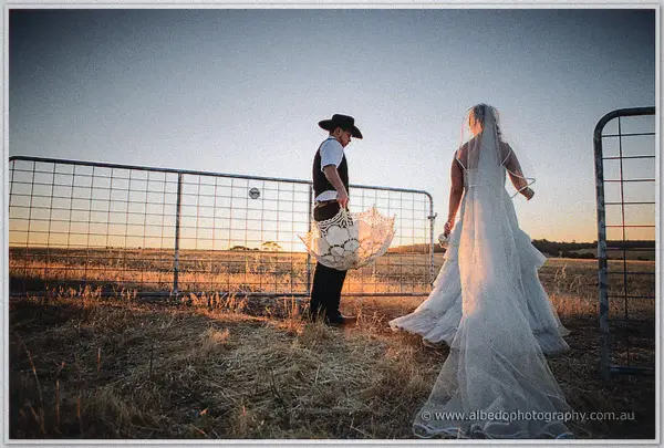 Gary opens a lace parasol by the farm gate as Tash's veil drifts on the evening breeze