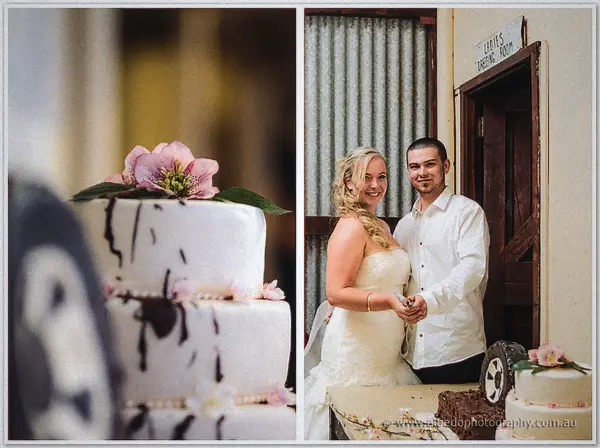 Chocolate-drip cake with pink blooms beside Tash and Gary at the cake table near the gear shed