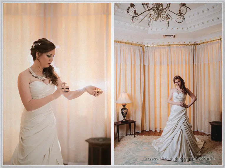 Amanda dabbing perfume and posing with hand on hip beneath the bridal suite chandelier