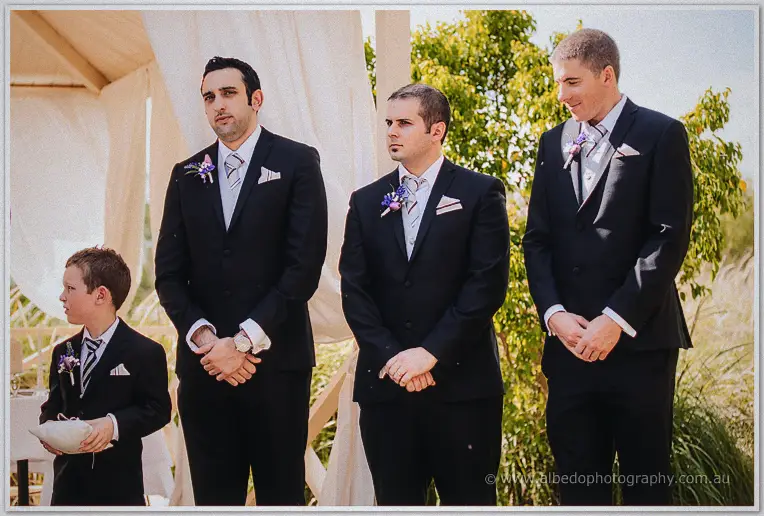 Craig's groomsmen and the page boy waiting at the front of the garden ceremony