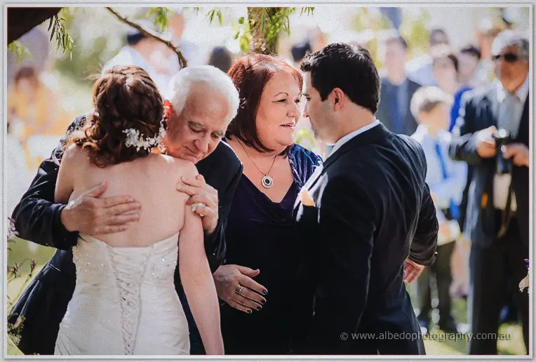 Amanda embraces her father while her mother and Craig exchange warm words nearby