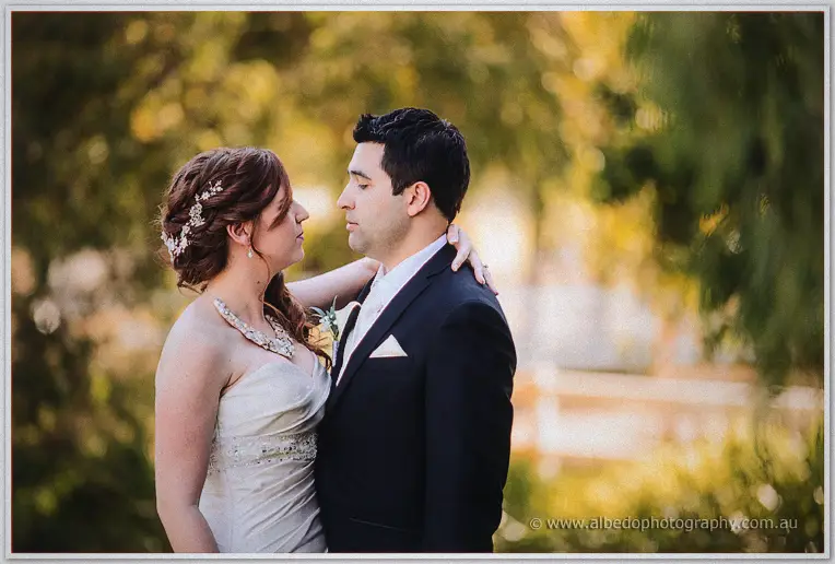 Amanda rests her hand on Craig's shoulder as they gaze at each other in warm evening light