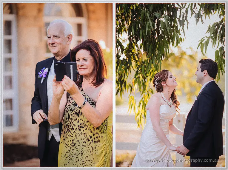 Parents watch proudly and the couple laugh together hand in hand under golden gum leaves