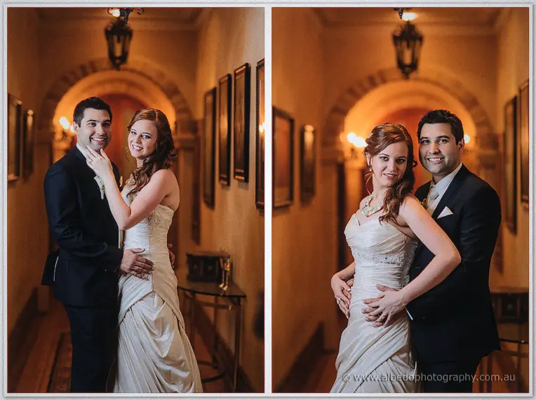 Amanda and Craig pose arm in arm under warm arches, her hand on his chest