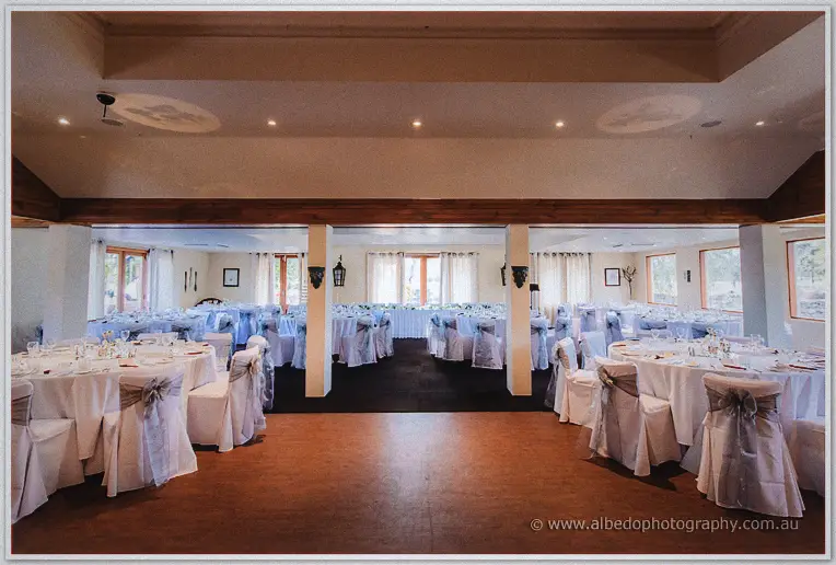 Round tables with silver sashes fill the sunlit reception room ready for the Swan Valley wedding breakfast
