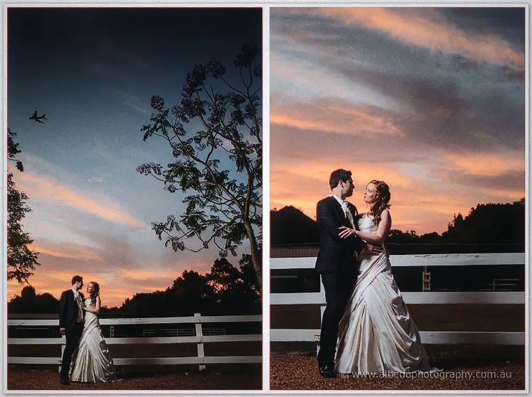 Craig and Amanda embrace by the white paddock fence under a blazing sunset, an aeroplane crossing high above