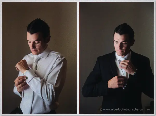 Diptych of groom Joe fastening his watch then buttoning his dark suit in moody window light