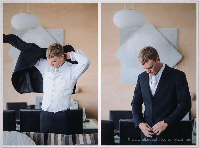 Diptych of the groom shrugging on his dark jacket, then buttoning it under a pendant lamp