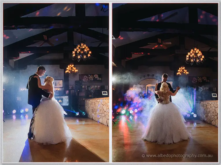 Steph and Luke's first dance in a haze of fog and coloured lights beneath the chandeliers