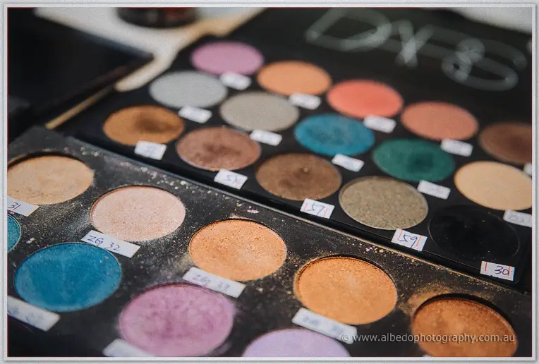 Teal, copper and plum eyeshadow palettes laid out for Elena's bridal makeup