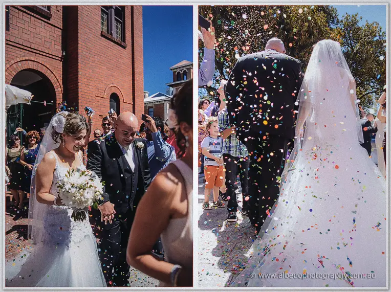 Elena and James beam through a shower of colourful confetti outside the red-brick Northbridge church