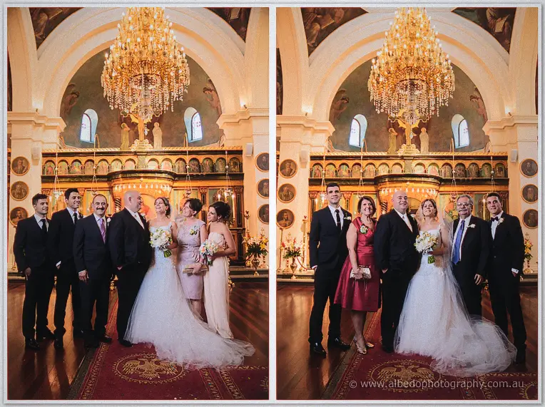 Elena and James pose with family beneath a giant crystal chandelier inside the icon-filled Orthodox church