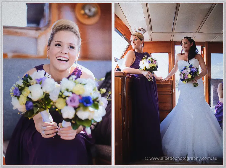 A laughing bridesmaid clutches two bouquets inside the timber cabin while Haley smiles from the cabin doorway