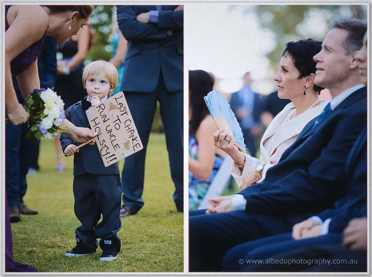 A page boy clutches his 'Last Chance to Run Uncle Holsty' sign beside seated wedding guests