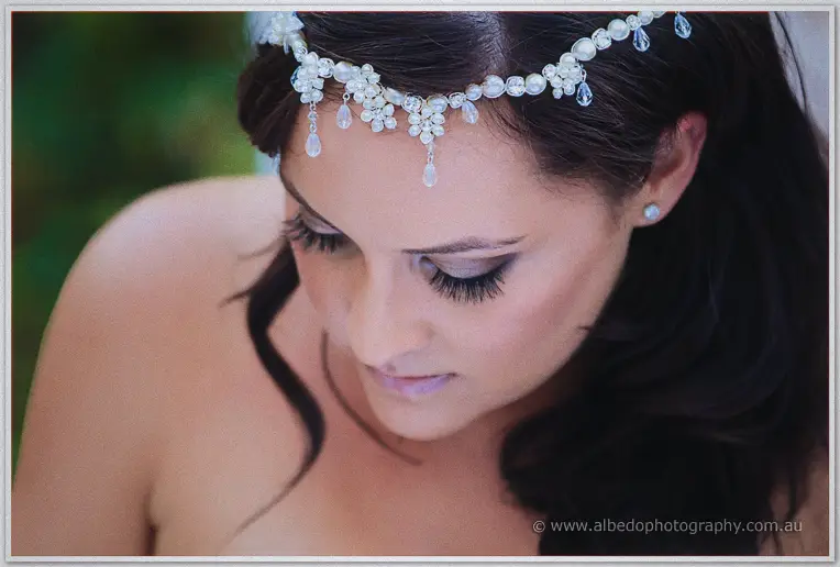 Close-up of Haley's pearl and crystal headpiece catching the light as she glances down thoughtfully