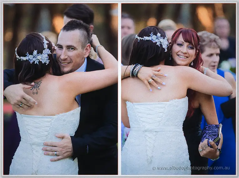 Haley embraces guests after the ceremony, her lace gown and butterfly tattoo visible as she hugs a friend.