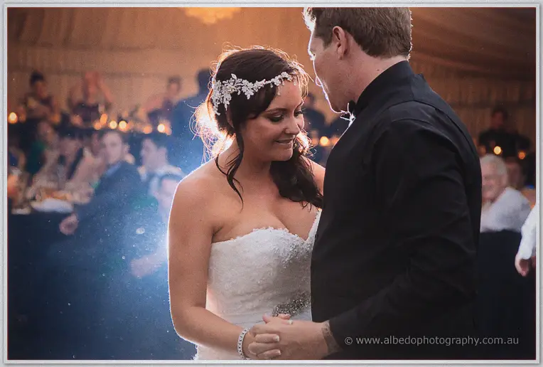 Haley in a crystal headpiece dances cheek to cheek with Matt amid candlelight and guests