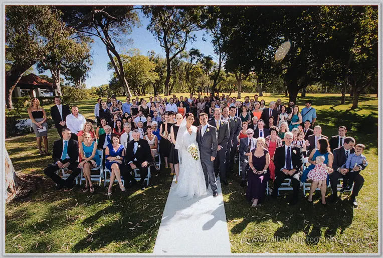 The whole guest crowd poses with the newlyweds on the aisle at their Matilda Bay ceremony.