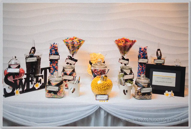 Jars of lollies and a SWEET sign dress the candy buffet at Stacey and Nathain's Matilda Bay reception.