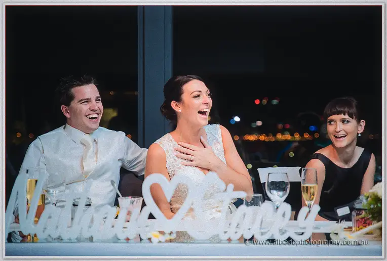 The bridal table erupts in laughter, Stacey clutching her chest as Nathain cackles alongside.