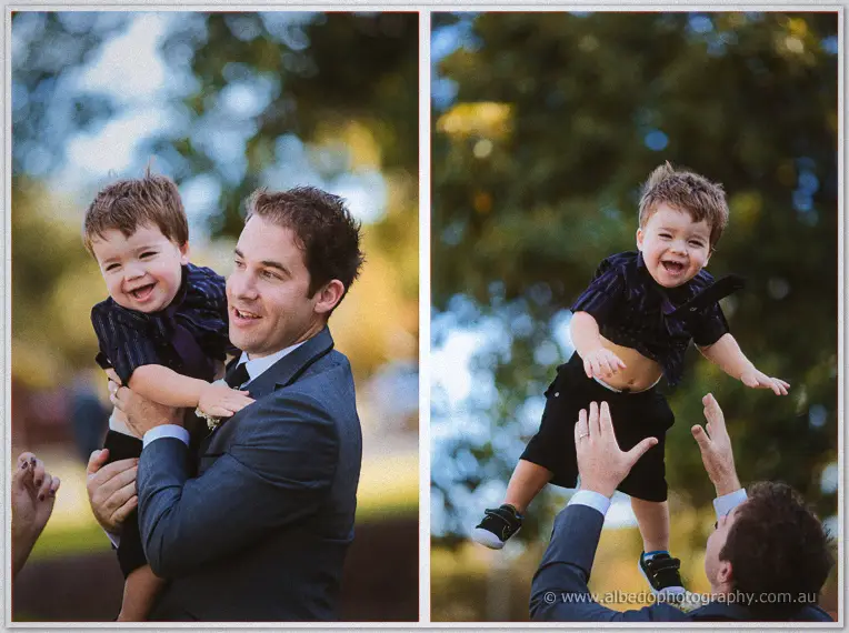 A groomsman tosses a giggling toddler skyward in dappled park shade, two-frame sequence