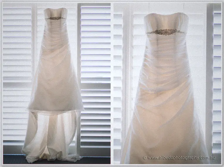 Elisha's strapless gown hangs at the shutters, its draped skirt pooling in a two-frame study.