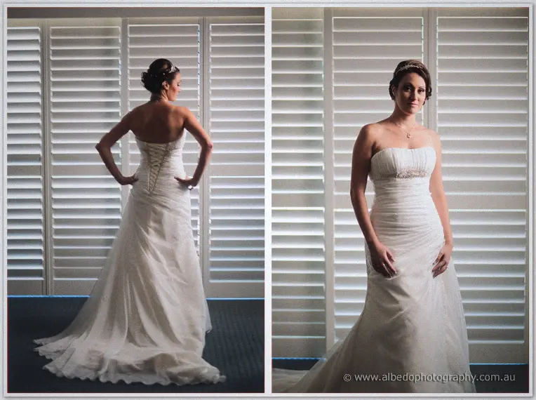 Corset lacing on the back of Elisha's gown, paired with a front view of her hands clasped by the shutters