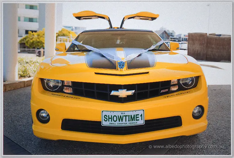 Front of the yellow wedding limo with ribbon bow and SHOWTIME1 plates, doors raised
