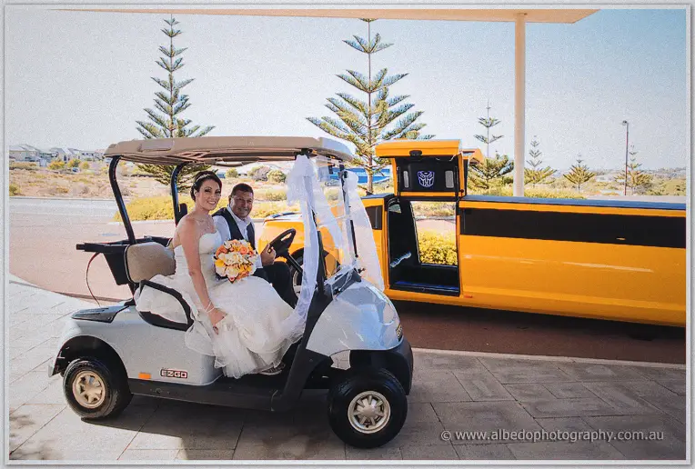 Elisha rides a white golf buggy with her father past the waiting stretch limo