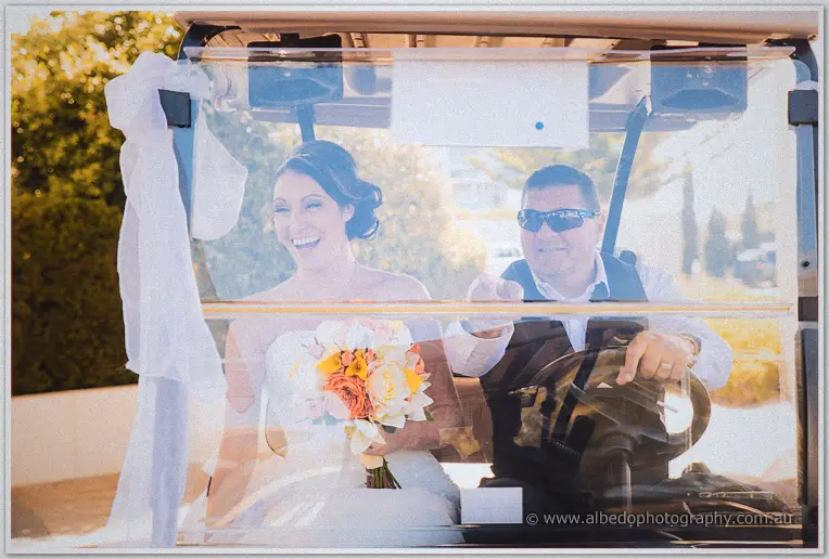 Elisha laughs in the decorated golf cart as her driver steers through golden afternoon light