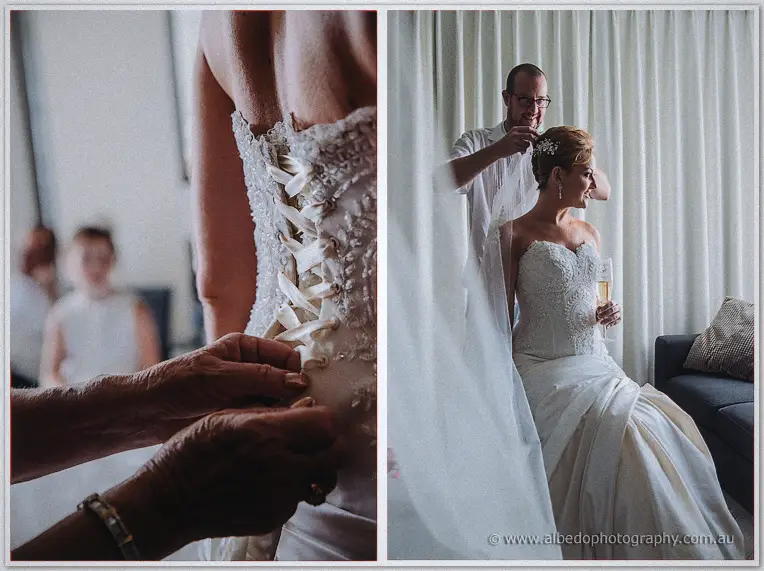 Ribbon laces up Kristina's corseted back, then a stylist drapes her veil as she holds champagne