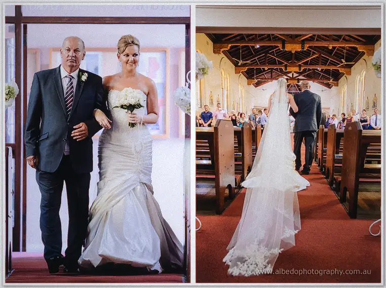 Kristina enters on her father's arm, then the pair walk the red aisle under timber rafters