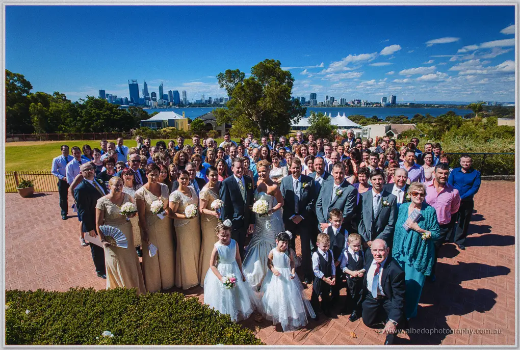 All the guests cluster on a brick terrace with the Perth skyline and river behind
