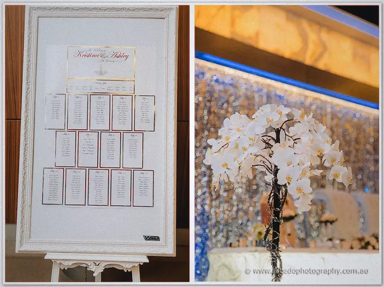 Framed seating chart and white orchid centrepiece welcome guests in the Astral Ballroom