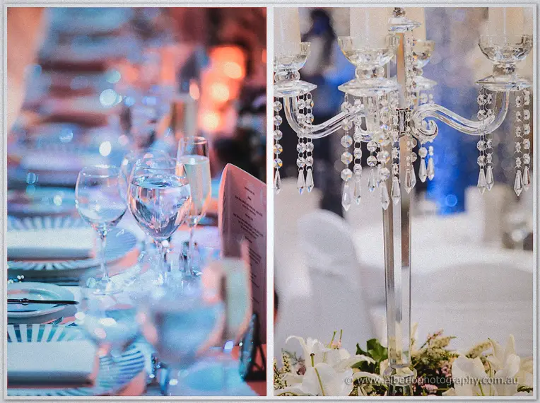 Crystal glasses catch the blue light along the bridal table beside a crystal candelabra