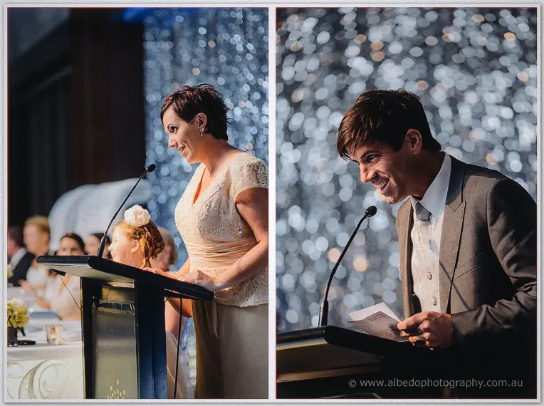A bridesmaid and the best man smile through their speeches at the ballroom podium